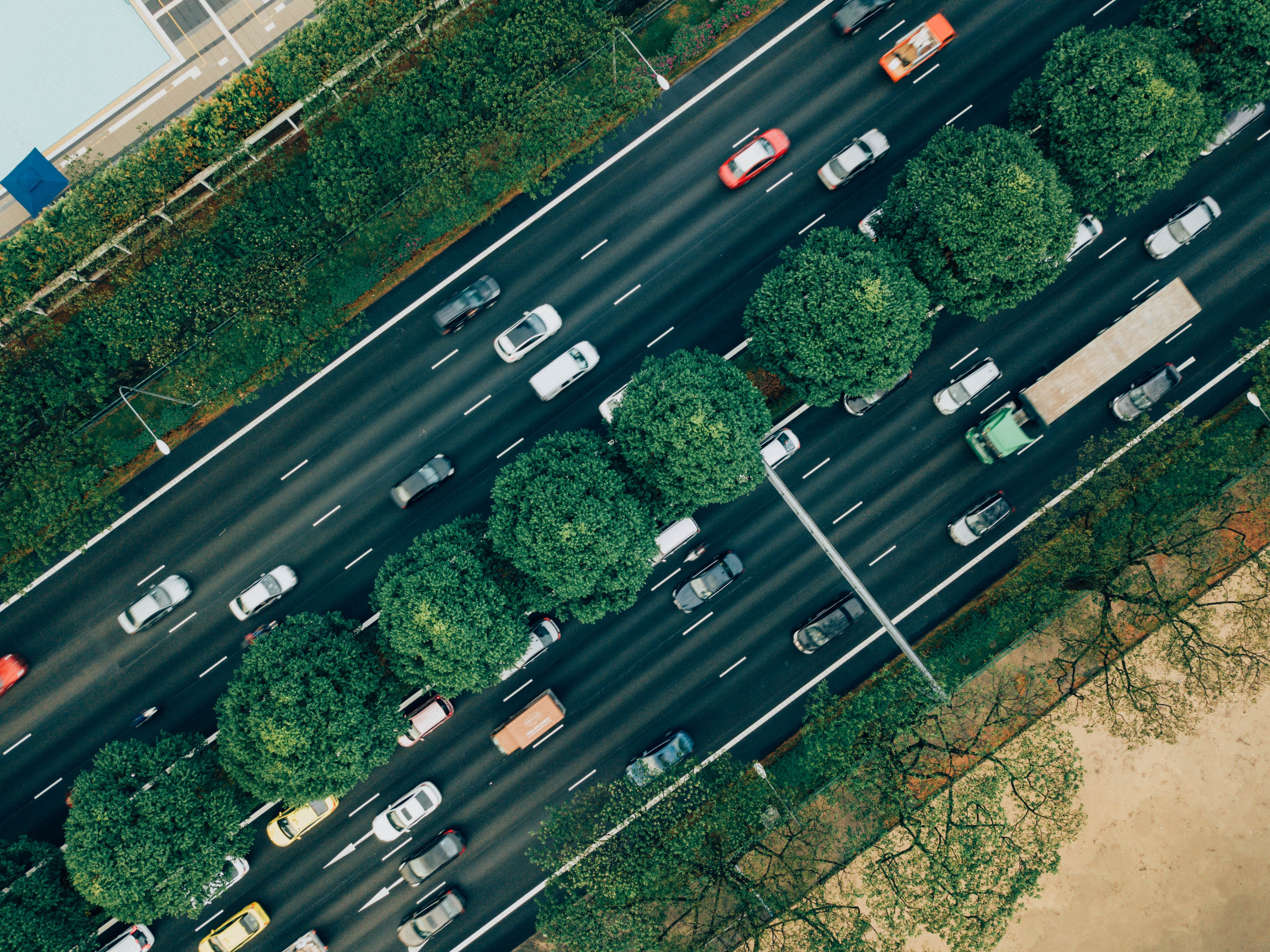 Topview of multi lane highway with trees in the middle