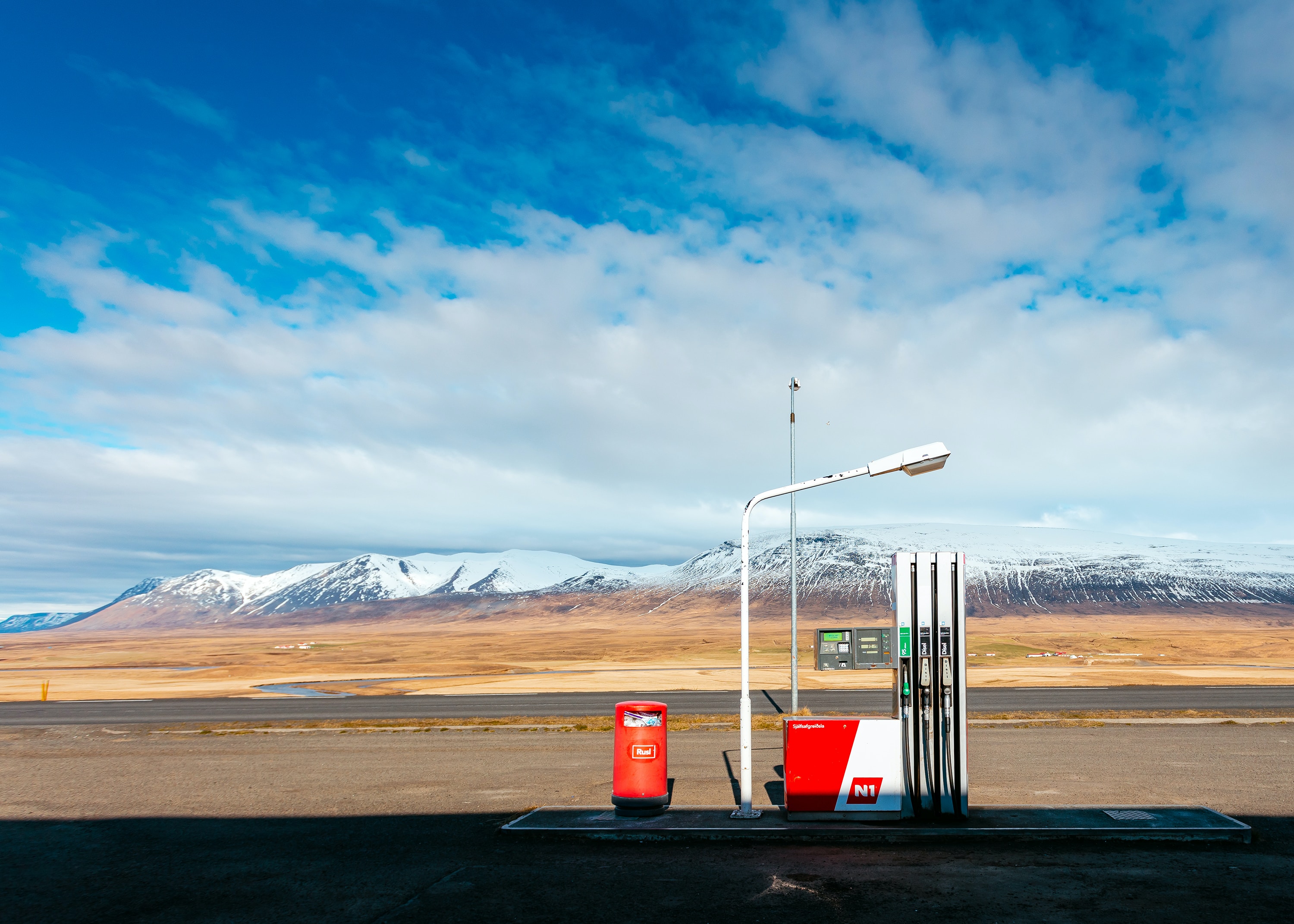gas pump in front of desert with mountain range in the background