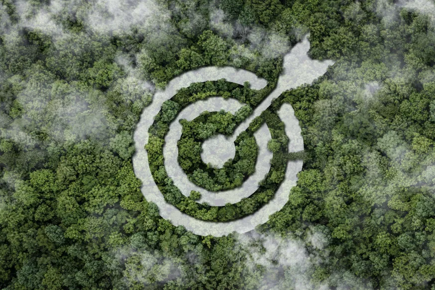 Stylized target with arrow integrated into a drone shot of a rainforest.